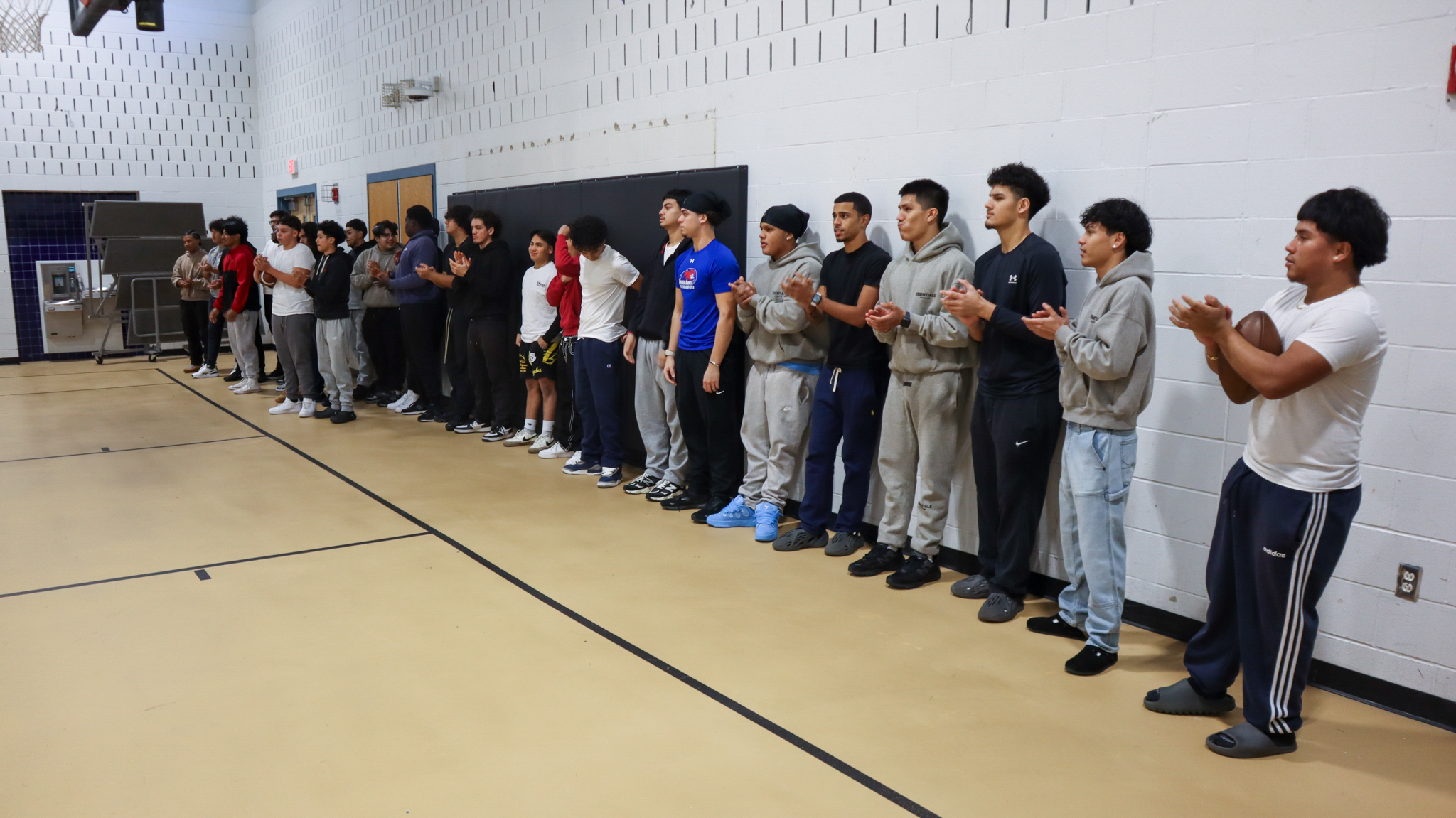 The CHS football team lined up together in the Blue Gymnasium